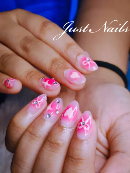 A sweet and delicate pink jelly nail set. The design includes hand-painted hearts and bows, accented with tiny silver rhinestones.