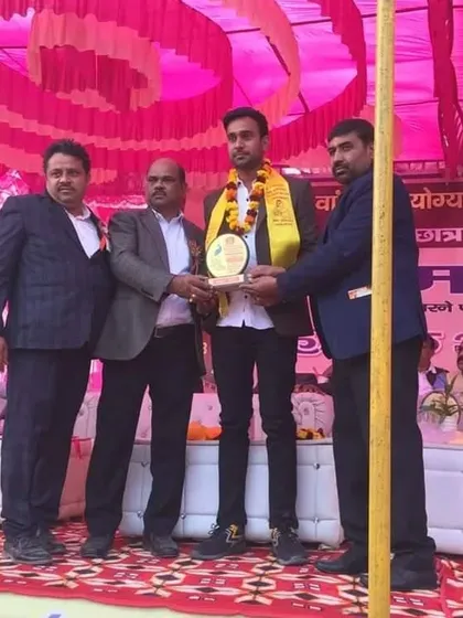Receiving an award on stage at a youth event in Delhi.