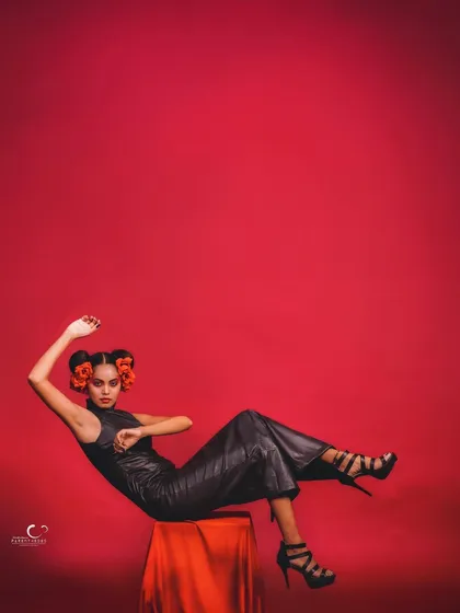 A dynamic, reclining pose that is both elegant and daring. The use of negative space is excellent, drawing the eye to the subject.