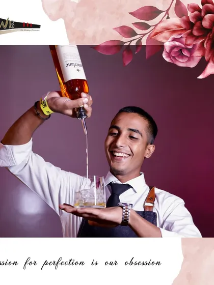 A happy bartender pours a drink with a flourish, adding a bit of showmanship to the guest experience.