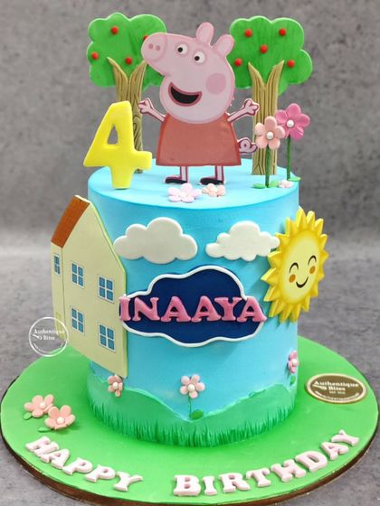 A cheerful Peppa Pig cake for a 4th birthday. This pineapple-flavored cake features Peppa in her happy world with her house, trees, and a smiling sun.