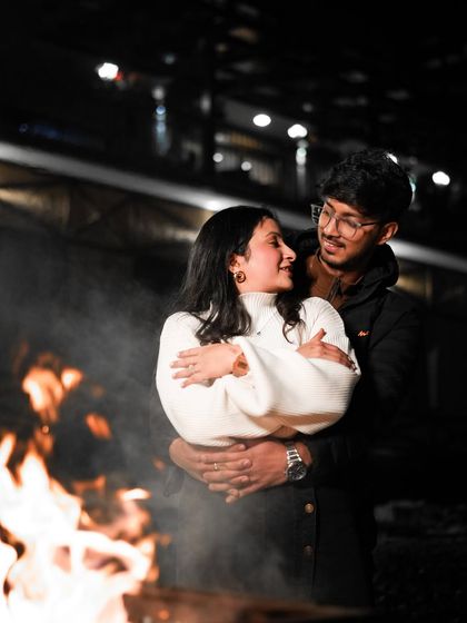 Cozying up by the bonfire on a cold, snowy night in Himachal. These are the warm, intimate moments that make a pre-wedding shoot so special.