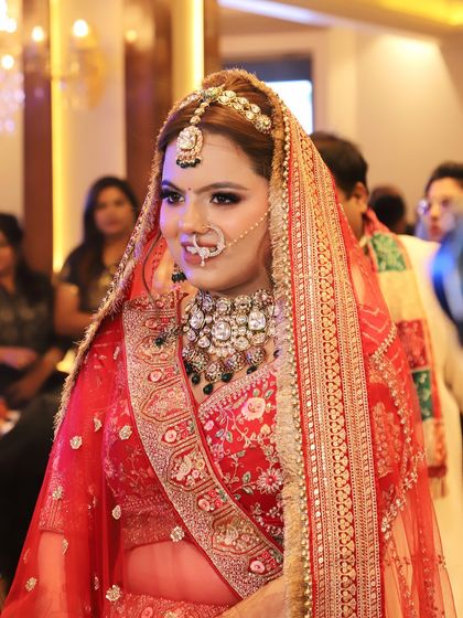 A candid shot of a smiling bride, her happiness making the makeup shine even brighter.