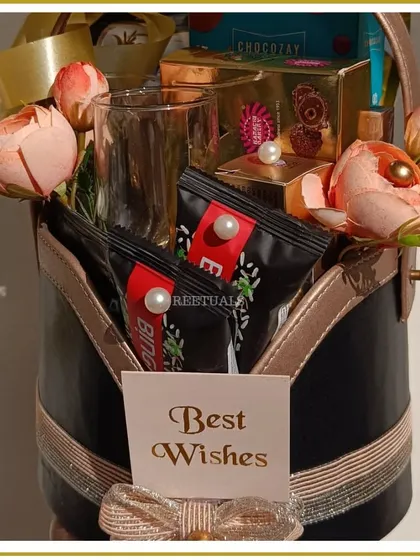 The front view of the classic anniversary hamper, with a "Best Wishes" card, all presented in a stylish black and gold leatherette basket.