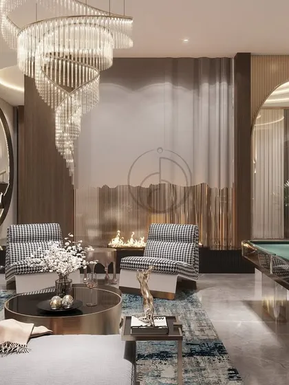 This casual lounge balances leisure and luxury, featuring a modern fireplace, a pool table, and comfortable seating. The spiral chandelier and marble accent wall add a touch of drama and sophistication.