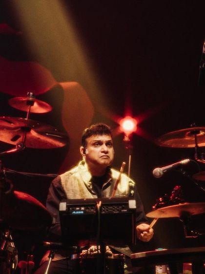 Our drummer, Tarun Bangalore, holding down the groove with intense focus. His powerful drumming drives the energy of our large-scale fusion performances.