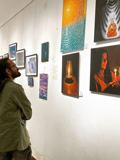 Visitors taking a closer look at my candle-light series.