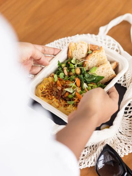 A healthy meal ready to be enjoyed. Our takeaway containers are eco-friendly, and the food inside is always packed with a wide spectrum of vegetables, grains, and plant-based protein.