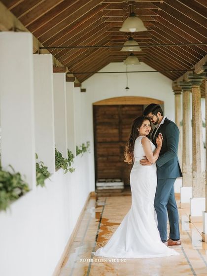 An intimate portrait of the couple in a beautiful architectural corridor, their embrace full of love and tenderness.