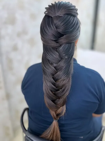 A clean, intricate mermaid braid hairstyle created during a student demonstration. We teach modern and traditional hairstyling techniques that are in high demand for events and weddings.