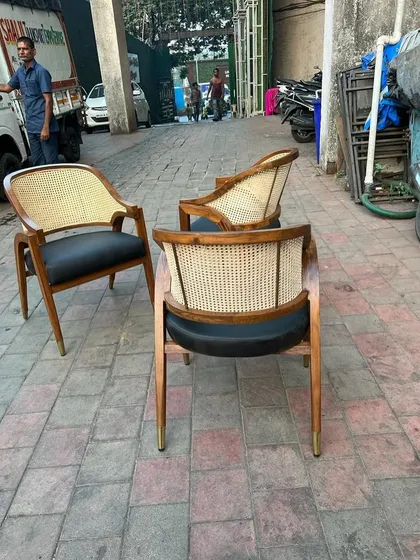 Three of the dining armchairs, showing front and back profiles.