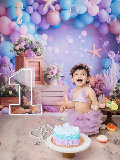 Look at that pure, unfiltered joy! A first birthday is a huge milestone, and my mermaid-themed cake smash sessions are perfect for making a huge, happy splash to celebrate.