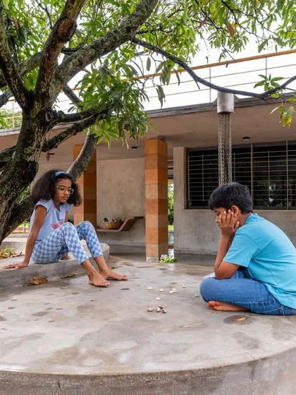 The concept of 'Jagli katte', a traditional sitting verandah, is central to the 'Aamra' project. Here, it becomes a space for leisure and connection, demonstrating how landscape design can foster slowness and unhurried activities within a natural setting.