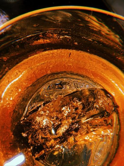 A close up of the 'King Kunta' cocktail, showing the gold flakes suspended in the drink. I focus on these small, luxurious details to create visually rich content that showcases the quality and creativity of a menu.