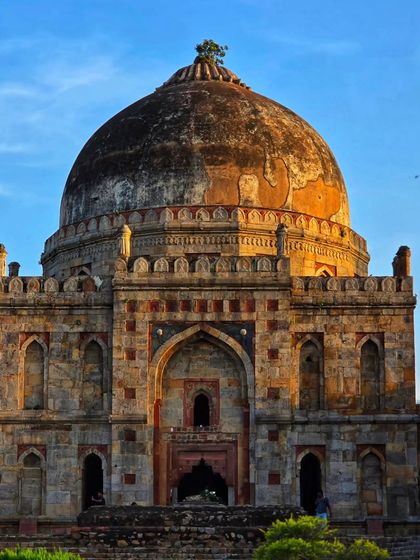 A direct, symmetrical shot of the main tomb at Lodi Garden, bathed in the warm light of the setting sun. A classic view of this iconic Delhi landmark.