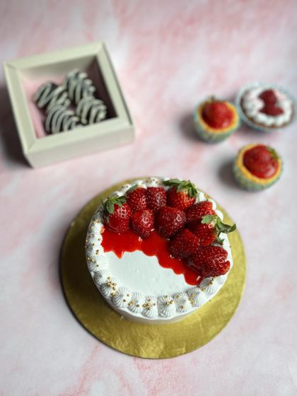 A glimpse of our dispatch table during strawberry season. Here we have a strawberries and cream cake, chocolate-dipped strawberries, and bite-sized strawberry tarts ready to go to their new homes.