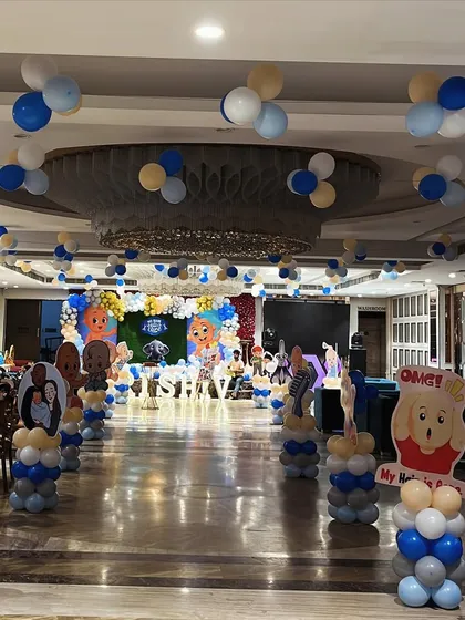 A wide view of the hall for the Mundan ceremony, showing how we decorated the entire space with themed balloon pillars and cutouts.