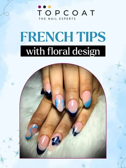 A modern twist on a classic. This design features dark blue French tips with abstract swirls and delicate, hand-painted floral accents.