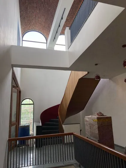 The Brick Vault House showcases my work in adaptive reuse. A feature spiral staircase ascends through a multi-height volume, crowned by a massive, exposed brick vault that defines the character of the entire residence.