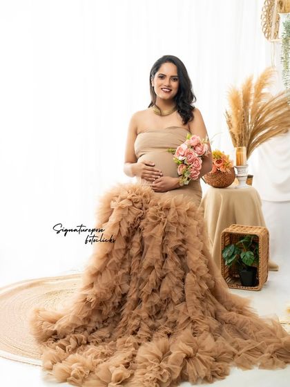 A seated portrait with the ruffled gown spread around, creating a beautiful sea of texture. The bouquet adds a soft, romantic touch.