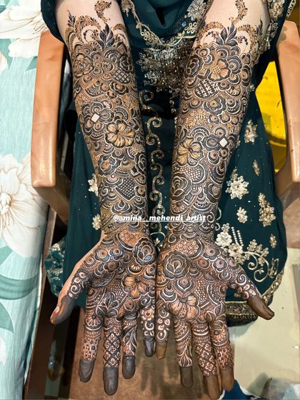 A beautiful example of full-hand mehendi where the palms are filled with detailed rose patterns, a favorite among my brides.