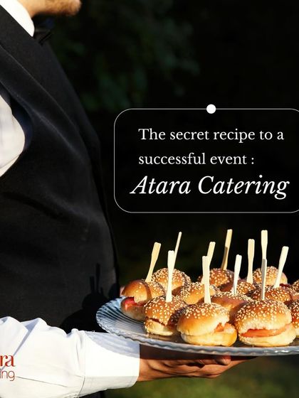 The secret recipe to a successful event is Atara Catering. Our professional server carries a tray of mini burgers, representing our commitment to excellent service.