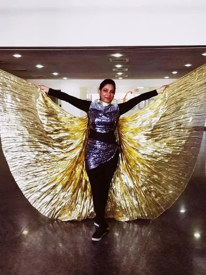 Posing with the belly wings before a corporate show. We ensure our dancers and costumes are stage-ready to deliver a professional and polished performance for your company event.