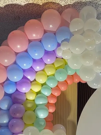 A beautiful pastel rainbow balloon arch, a popular and cheerful choice for baby showers and first birthdays.