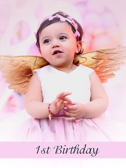 A sweet portrait of a little girl on her first birthday, dressed as an angel. This image is perfect for birthday invitations or thank you cards.
