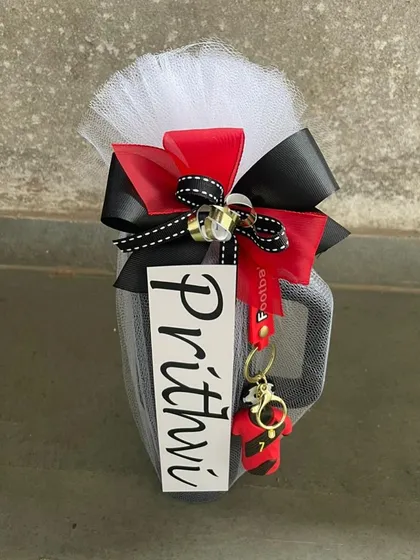 A personalized mug for "Prithvi," with a red and black theme to match his favorite football team. These details make each gift feel special and unique.