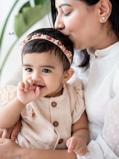 A mother's gentle kiss on her baby's head. A simple, beautiful expression of love.