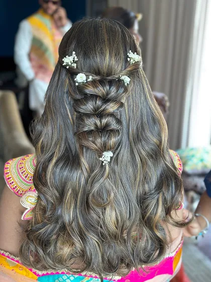 Happiness is a good hair day. This intricate half-up style features a beautiful pull-through braid and soft waves.