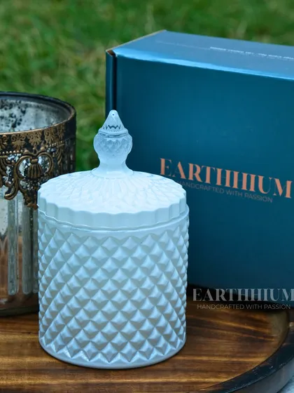 The lidded diamond-cut jar on its own, showcasing its intricate texture. The jar can be repurposed to hold trinkets or jewelry once the candle has been enjoyed.