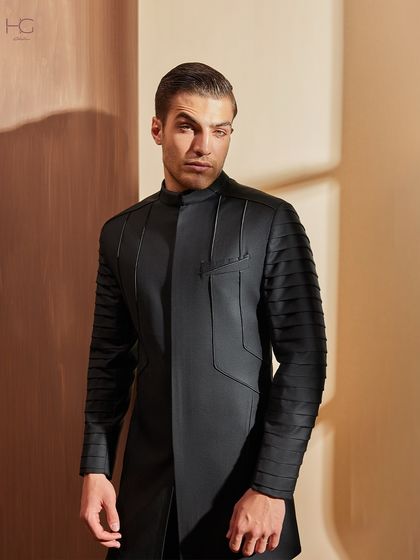 For a look that is anything but basic, I designed this achkan with pleated sleeves. The structured, ribbed texture on the arms adds a bold, modern edge to the traditional silhouette.