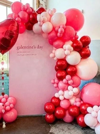 A closer look at the Valentine's Day balloon arch, highlighting the mix of different sized balloons that create a rich texture. This setup is perfect for creating memorable photos.