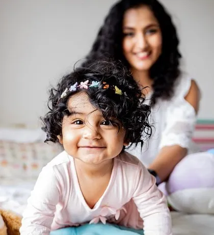 That curious crawl towards the camera, the cheeky grin, and those gorgeous curly locks. This is the essence of a toddler photoshoot. I focus on capturing their playful spirit in a relaxed setting, like their own bedroom, surrounded by their favorite toys.
