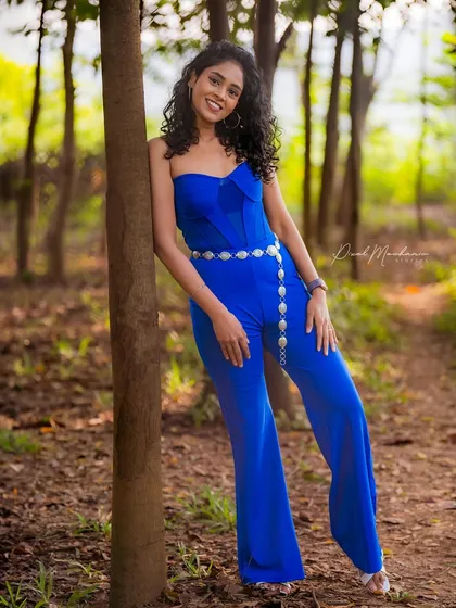 We found this perfect spot in a quiet park, where the natural light filtered through the trees. The goal for this model portfolio shot was to create something that felt both powerful and serene, letting the vibrant blue of the outfit stand out against the earthy tones of the woods.