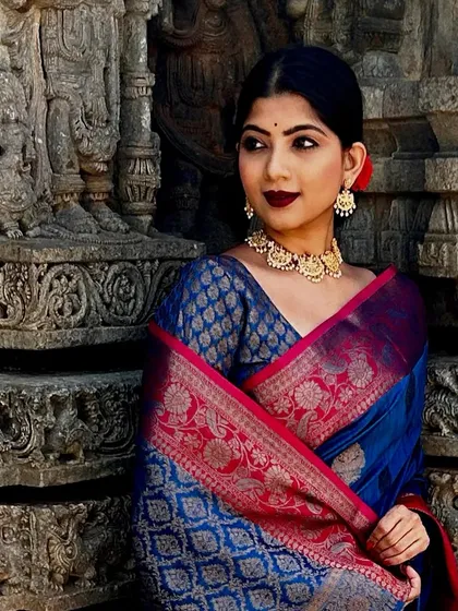 Modeling a magnificent royal blue and pink Kanjivaram silk saree against the backdrop of ancient temple carvings. This shoot was about capturing a feeling of queenly elegance and reverence, letting the rich fabric and traditional jewelry shine.
