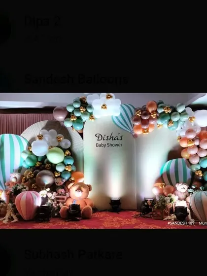 A charming baby shower setup with a hot air balloon theme. The decor uses pastel green and brown balloons with teddy bear props for a gentle, adventurous feel.