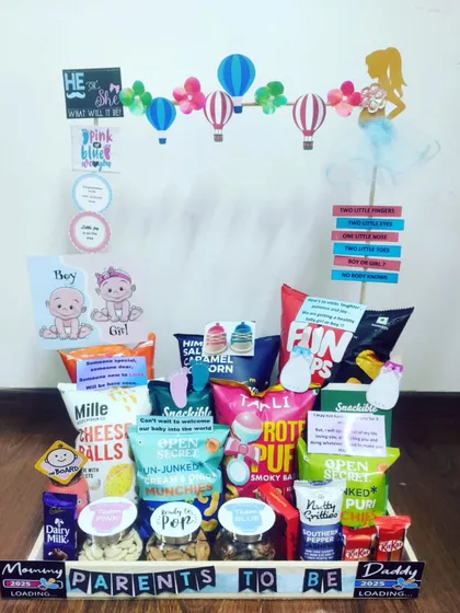 For the parents-to-be, I design these survival kits packed with a mix of healthy and indulgent snacks. This hamper has a fun gender-reveal theme and is filled with treats for both mom and dad to enjoy while they await their new arrival.