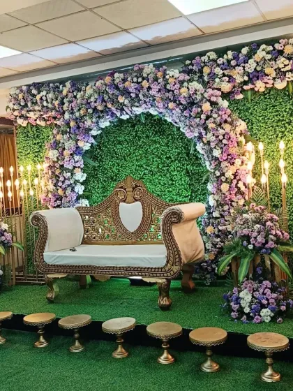 This photo shows the half-saree decoration with small stools placed in front of the stage. These are often used for placing various items as part of the ceremony rituals.