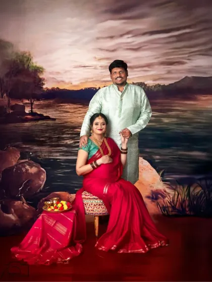 Seated against a painted backdrop reminiscent of classical Indian art, this couple's portrait is a unique and artistic celebration of their growing family.