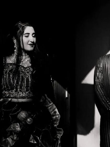 A two-shot portrait in black and white, with the bride and groom separated by light and shadow. This is a creative and unconventional couple portrait.