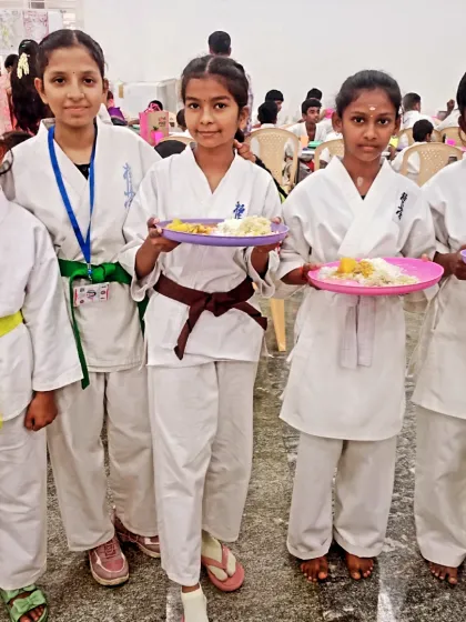A group of my junior and senior female students posing with their breakfast. They are all fueled up and ready for the tournament.
