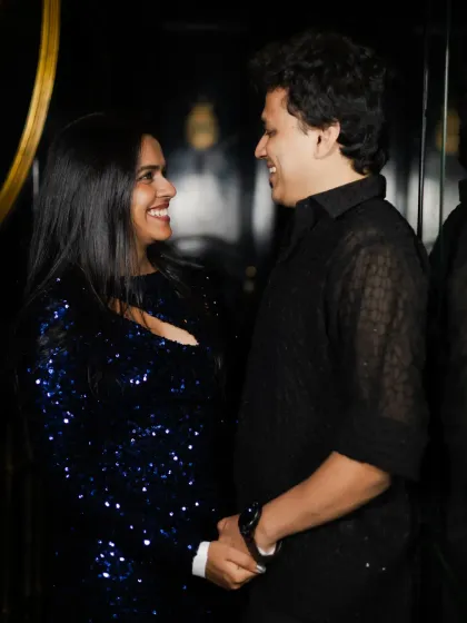 A happy, candid shot of the couple sharing a laugh. Their genuine smiles show the joy of their celebration.