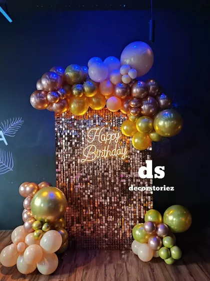 Make your event unforgettable with a glamorous shimmer wall. This rose gold sequin backdrop, framed by an organic balloon garland and a 'Happy Birthday' neon sign, creates the perfect photo opportunity for clubs, milestone birthdays, or any chic party.