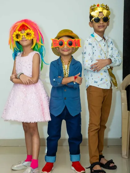 My box of selfie props brings out the fun in everyone. These kids are showing off their cool new looks with colorful wigs, silly glasses, and party chains.