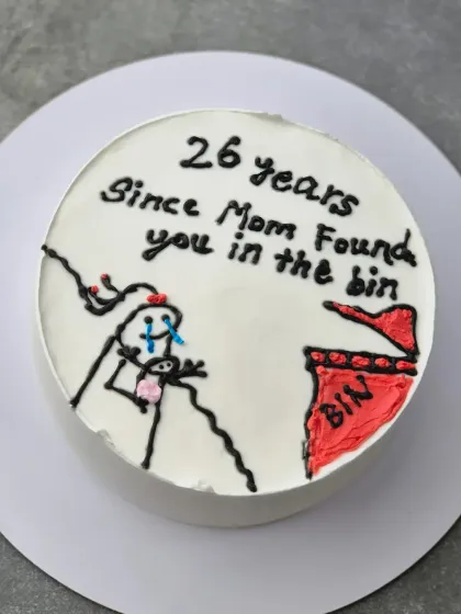 The full view of the "26 years since Mom found you in the bin" cake. This Vanilla Nutella Chocolate cake is a great example of a fun, personalized request.