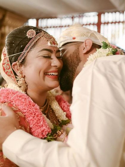 The pure joy of a newly married couple. This candid embrace, filled with laughter and relief, is one of those priceless moments right after the ceremony.