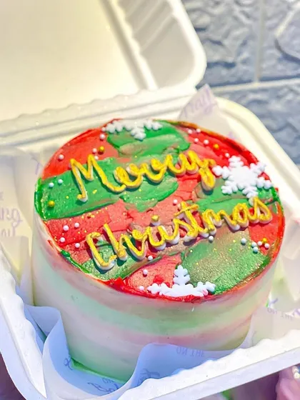 My "Merry Christmas" bento cake with festive red and green watercolor frosting. It’s a cheerful and delicious way to celebrate the season.